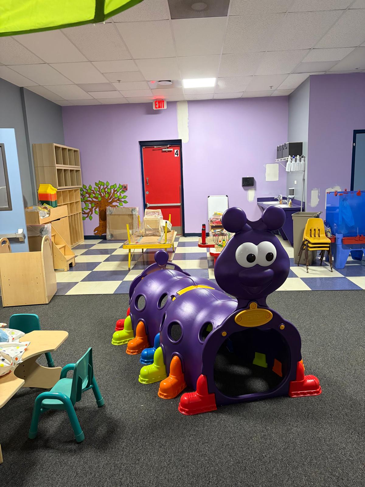 Colorful classroom with play tunnel and learning stations