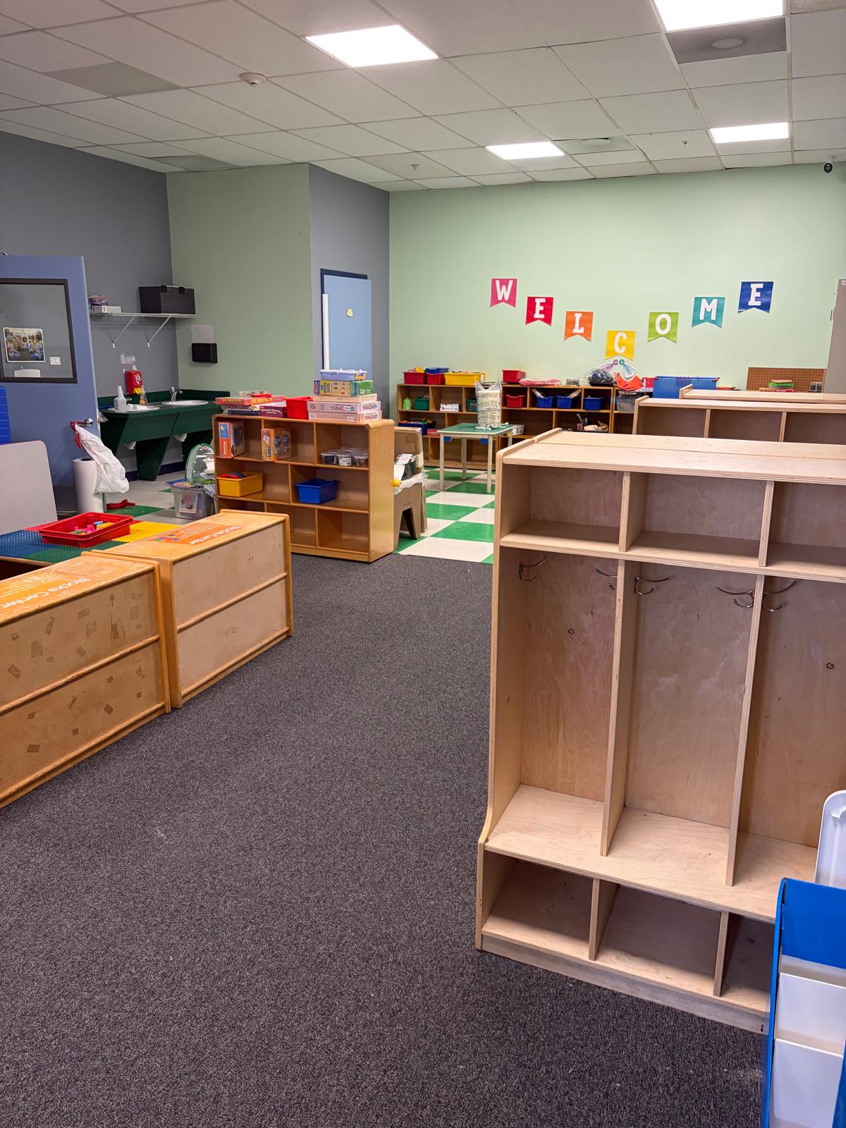 Welcome area with wooden cubbies and learning materials