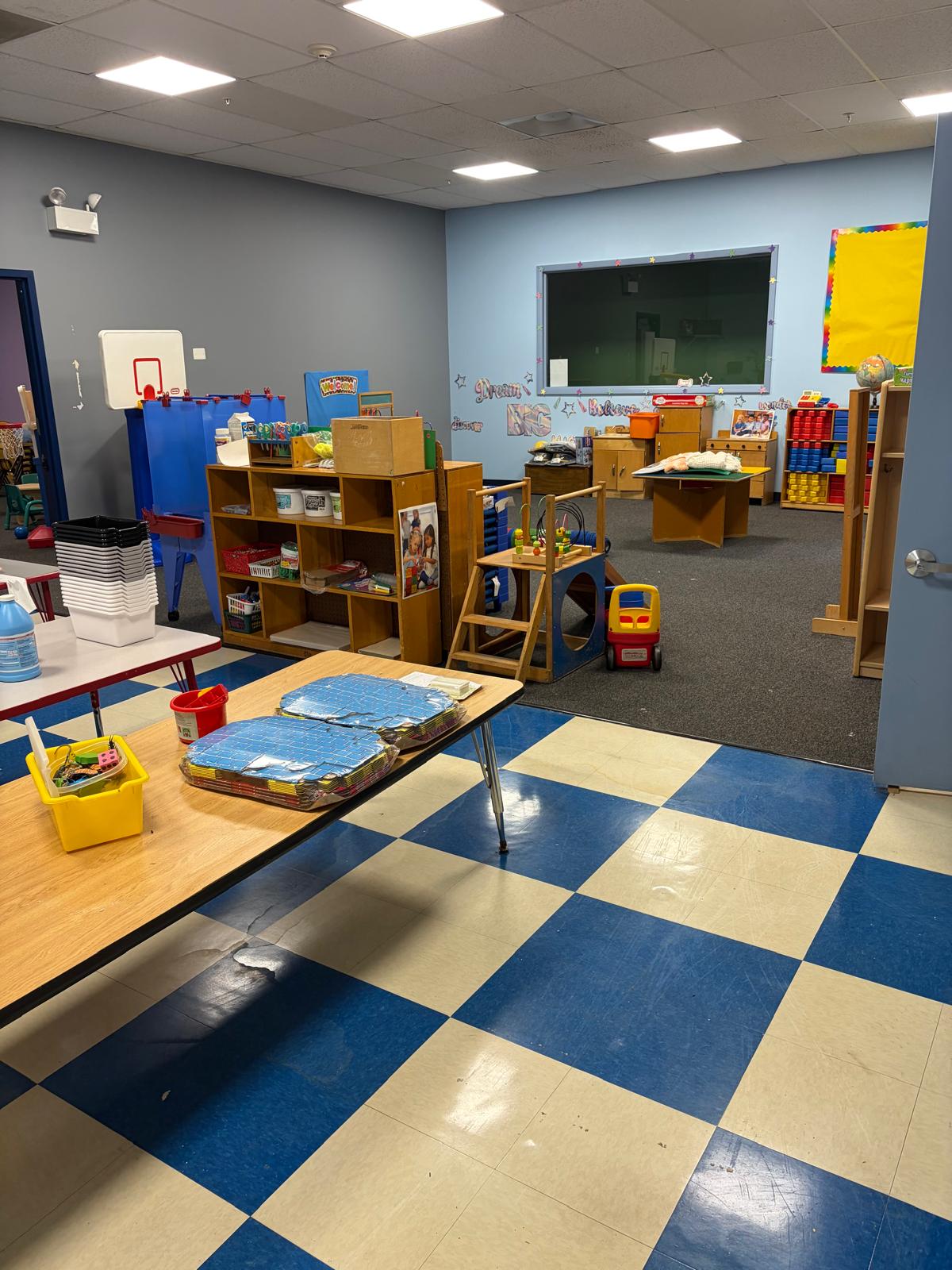 Spacious open classroom with bookshelves and learning centers